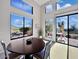 Dining area with views of the desert landscape, a table, and seating indoors and on the patio at 13503 E Summit Dr, Scottsdale, AZ 85259