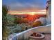 A cozy outdoor firepit with desert landscaping and scenic sunset views of the mountains at 13503 E Summit Dr, Scottsdale, AZ 85259