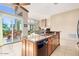 Open-concept kitchen with an island and counter seating, and views to the dining and living areas at 13503 E Summit Dr, Scottsdale, AZ 85259