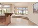 Bright living room with high ceilings, tile floors, and large windows offering views of the outdoor landscape at 13503 E Summit Dr, Scottsdale, AZ 85259