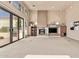 Bright living room boasting plush carpeting, a fireplace, and large sliding doors leading to an outdoor space at 13503 E Summit Dr, Scottsdale, AZ 85259