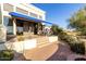 Spacious patio with seating area, tile flooring, and desert landscaping at 13503 E Summit Dr, Scottsdale, AZ 85259