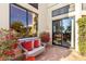 Cozy patio with wicker furniture and red accent pillows at 13503 E Summit Dr, Scottsdale, AZ 85259