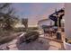 Sunset view of the patio with seating area and fire pit at 13503 E Summit Dr, Scottsdale, AZ 85259