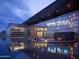Modern building with glass facade and reflecting pool at night at 140 E Rio Salado Pkwy # 111, Tempe, AZ 85281