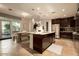 Gourmet kitchen with granite island, stainless steel appliances, and dark wood cabinetry at 140 E Rio Salado Pkwy # 111, Tempe, AZ 85281