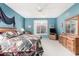 Bedroom with ceiling fan, dresser, and large window at 14140 W Green Hollow Ter, Litchfield Park, AZ 85340