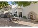 Relaxing backyard patio with fountain, dining area, and lush landscaping at 1519 E Treasure Cove Dr, Gilbert, AZ 85234