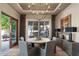 Elegant dining room with a round table, gray chairs, and access to a patio at 1519 E Treasure Cove Dr, Gilbert, AZ 85234