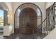Elegant entryway with arched wood doors and herringbone floor at 1519 E Treasure Cove Dr, Gilbert, AZ 85234