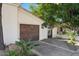 Single car garage with decorative gate and landscaping at 1519 E Treasure Cove Dr, Gilbert, AZ 85234