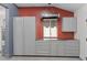 Organized garage workshop with stainless steel countertops and storage cabinets at 1519 E Treasure Cove Dr, Gilbert, AZ 85234