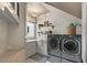 Bright laundry room with modern washer, dryer, and ample counter space at 1519 E Treasure Cove Dr, Gilbert, AZ 85234