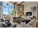 Bright living room with hardwood floors, a fireplace, and large windows with water views at 1519 E Treasure Cove Dr, Gilbert, AZ 85234