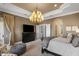 Spacious main bedroom with large TV and sitting area at 1519 E Treasure Cove Dr, Gilbert, AZ 85234