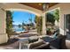 Covered patio with comfortable seating, offering stunning lake views at 1519 E Treasure Cove Dr, Gilbert, AZ 85234