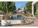 Resort-style pool with waterfall feature and natural rock landscaping at 1519 E Treasure Cove Dr, Gilbert, AZ 85234