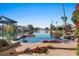 Stunning pool and patio area with lake views and a waterfall feature at 1519 E Treasure Cove Dr, Gilbert, AZ 85234