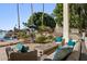Relaxing poolside patio with comfortable seating and lake views at 1519 E Treasure Cove Dr, Gilbert, AZ 85234