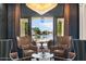 Elegant sitting area with lake view, armchairs and a glass-top coffee table at 1519 E Treasure Cove Dr, Gilbert, AZ 85234