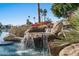 Serene waterfall feature cascading into a pool, near the lake at 1519 E Treasure Cove Dr, Gilbert, AZ 85234