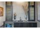 Elegant wet bar with dark cabinetry, quartz countertops and a wine cooler at 1519 E Treasure Cove Dr, Gilbert, AZ 85234