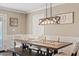 Dining area with a long wooden table and bench seating at 1637 N Bridalwreath St, Tempe, AZ 85288