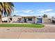 Charming single-story home with a well-manicured lawn and blue garage door at 1637 N Bridalwreath St, Tempe, AZ 85288