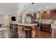 Modern kitchen with granite island, stainless steel appliances and dark cabinets at 1637 N Bridalwreath St, Tempe, AZ 85288