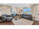 Living room with hardwood floors, gray sofas and a large window at 1637 N Bridalwreath St, Tempe, AZ 85288