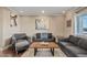 Bright living room featuring hardwood floors and comfy gray sofas at 1637 N Bridalwreath St, Tempe, AZ 85288