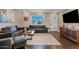 Spacious living room with dark hardwood floors, gray sofas and a large window at 1637 N Bridalwreath St, Tempe, AZ 85288