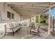 Covered patio with seating area and string lights at 1637 N Bridalwreath St, Tempe, AZ 85288