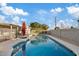 Inviting kidney-shaped pool with red umbrella at 1637 N Bridalwreath St, Tempe, AZ 85288