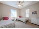 Bright bedroom with two twin beds, nightstands, and ceiling fan at 16916 W Eureka Springs Dr, Surprise, AZ 85387