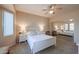 Bright bedroom with a white bed frame and mirrored closet doors at 16916 W Eureka Springs Dr, Surprise, AZ 85387