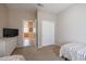 Guest bedroom with twin beds, built-in closet, and view of the bathroom at 16916 W Eureka Springs Dr, Surprise, AZ 85387