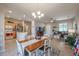 Bright dining area with a wooden table and chairs, and access to backyard at 16916 W Eureka Springs Dr, Surprise, AZ 85387