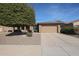 House exterior with mature tree and gravel landscaping at 16916 W Eureka Springs Dr, Surprise, AZ 85387