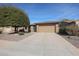 House exterior showcasing a two-car garage and well-maintained landscaping at 16916 W Eureka Springs Dr, Surprise, AZ 85387
