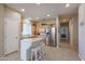 Modern kitchen with light wood cabinets, stainless steel appliances, and an island at 16916 W Eureka Springs Dr, Surprise, AZ 85387