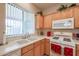 Bright kitchen features white appliances and light wood cabinets at 16916 W Eureka Springs Dr, Surprise, AZ 85387