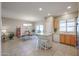 Spacious kitchen and dining area with an island and tiled floors at 16916 W Eureka Springs Dr, Surprise, AZ 85387