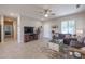 Comfortable living room featuring a sectional sofa and a large TV at 16916 W Eureka Springs Dr, Surprise, AZ 85387
