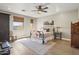 Bright bedroom with wood floors, a metal bed frame, and large windows at 17025 E La Montana Dr # 130, Fountain Hills, AZ 85268