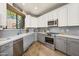Modern kitchen with gray cabinets, stainless steel appliances, and light wood flooring at 17025 E La Montana Dr # 130, Fountain Hills, AZ 85268