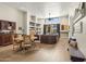 Light and airy living room with hardwood floors, a cozy leather couch, and built-in shelving at 17025 E La Montana Dr # 130, Fountain Hills, AZ 85268