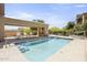 Community pool with lounge chairs and covered seating area at 17025 E La Montana Dr # 130, Fountain Hills, AZ 85268