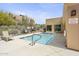 Community pool with a spacious deck and lounge chair at 17025 E La Montana Dr # 130, Fountain Hills, AZ 85268