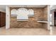 Stone accent wall with built-in shelving and granite counter at 1707 W Wayland Rd, Phoenix, AZ 85041